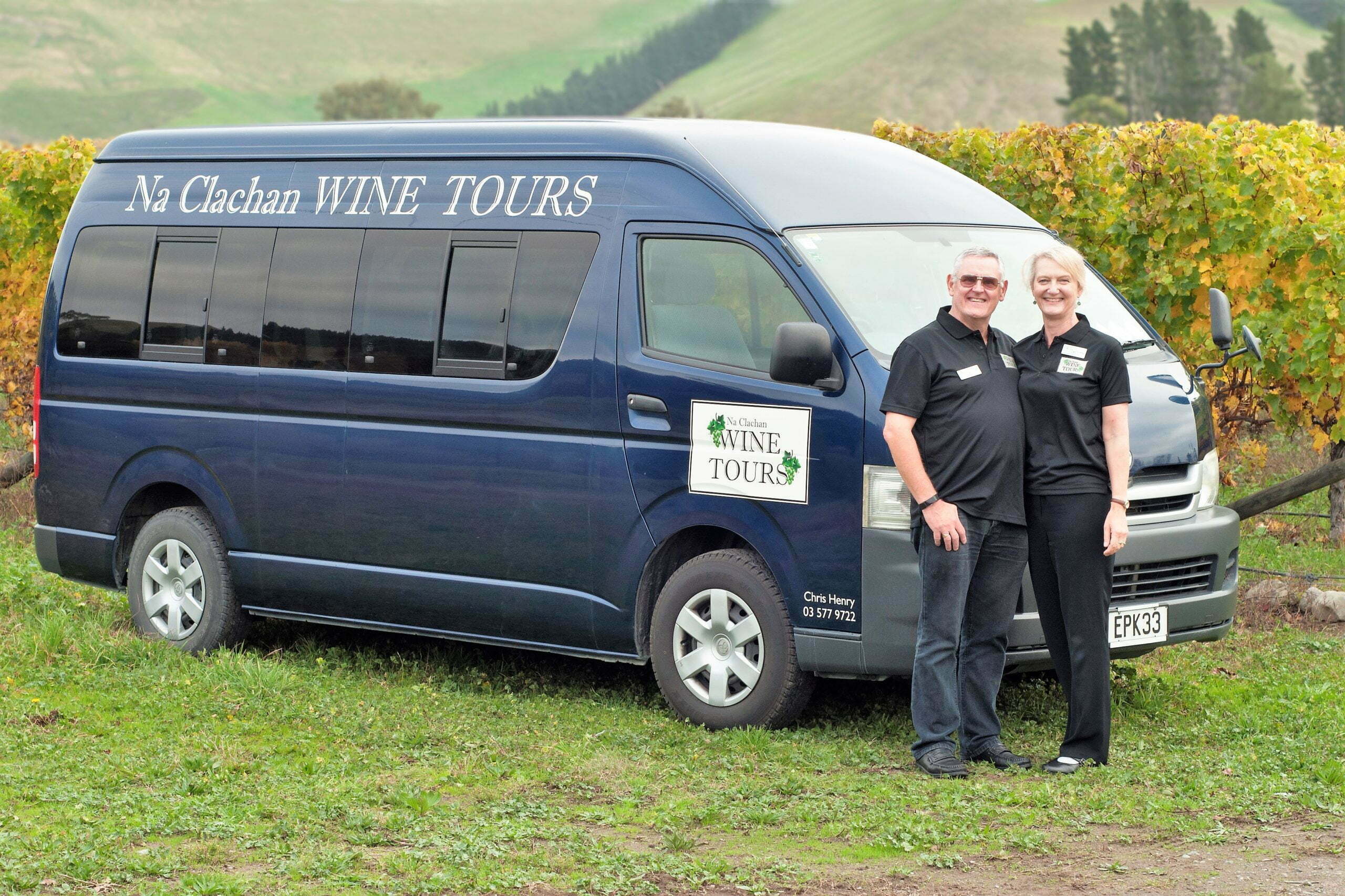 Chris and Lyndie posing with the minibus used for small group wine tours
