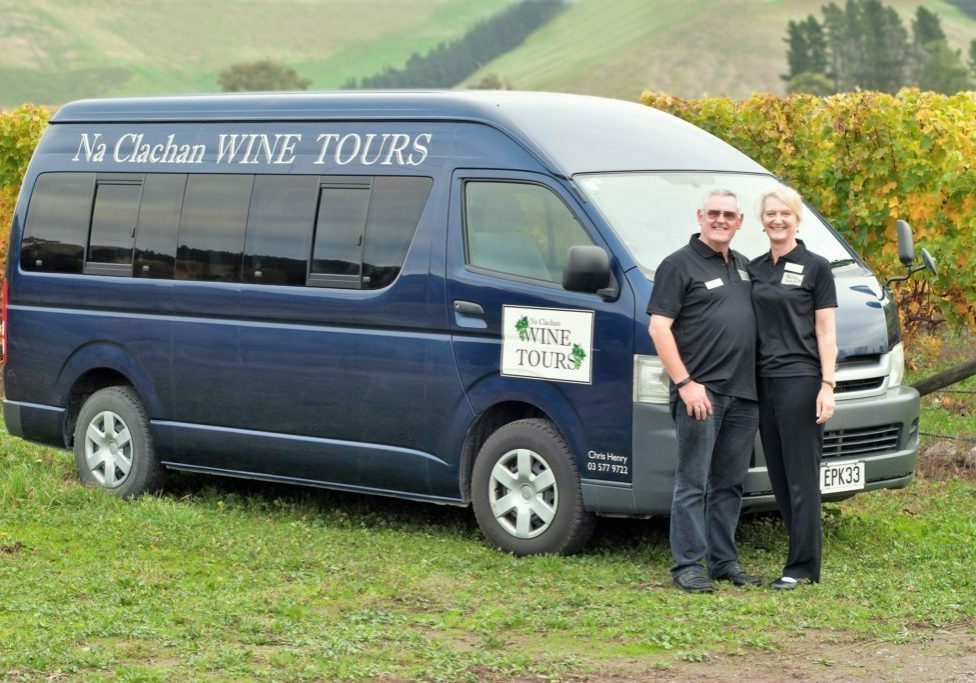 Chris and Lyndie posing with the minibus used for small group wine tours